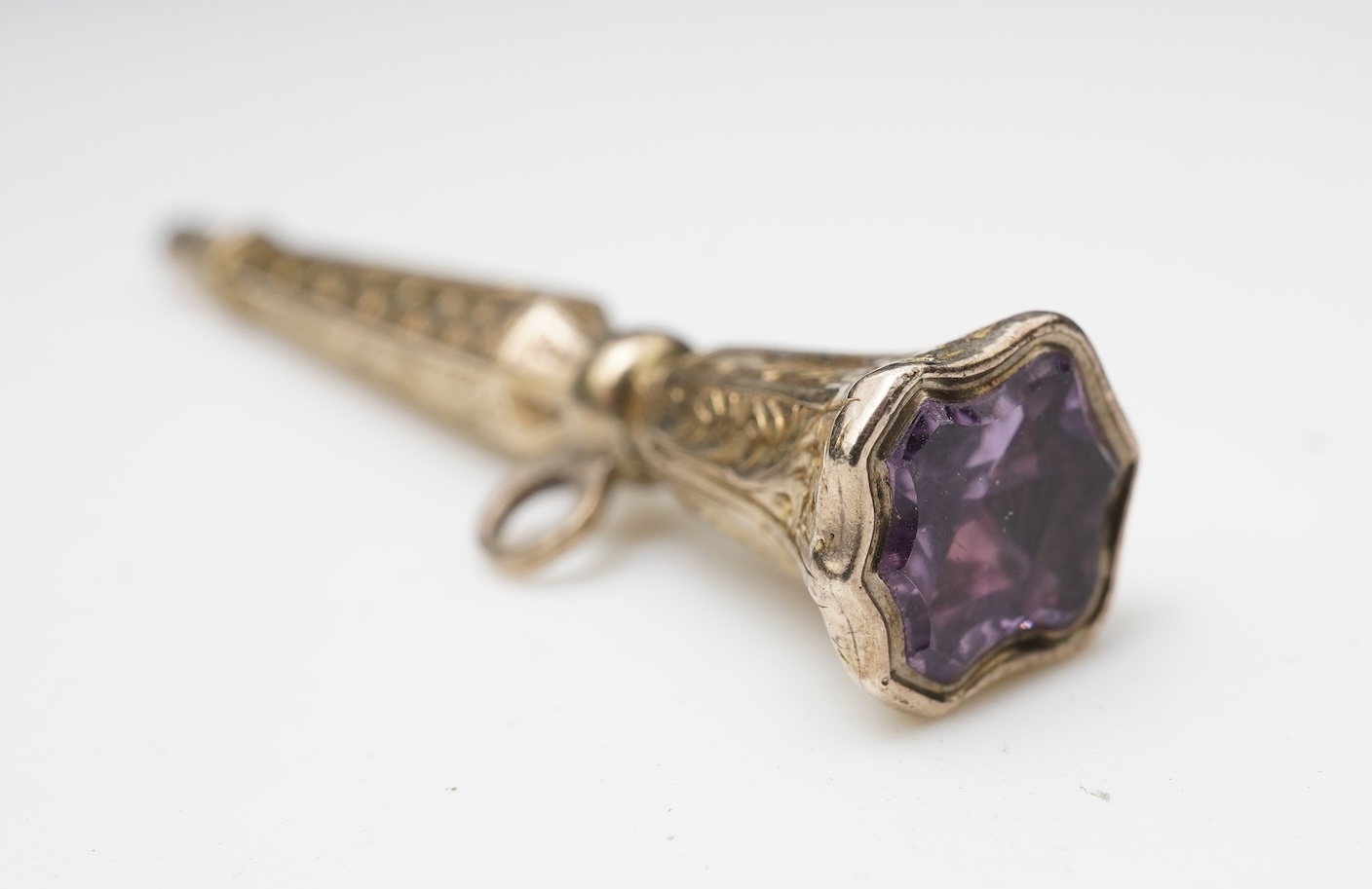 A small group of assorted collectables and jewellery including a Dunhill lighter, 64mm, a George V silver and enamel small compact, silver thimble, two Victorian garnet set brooches, an Edwardian 9ct, amethyst and seed p